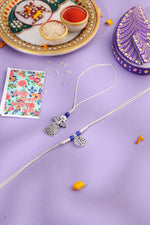 Thumbnail for NVR Set of 2 Silver Toned Pearls & Beads Bhaiya Bhabhi Rakhi with Roli Chawal Chandan & Mishri - Distacart