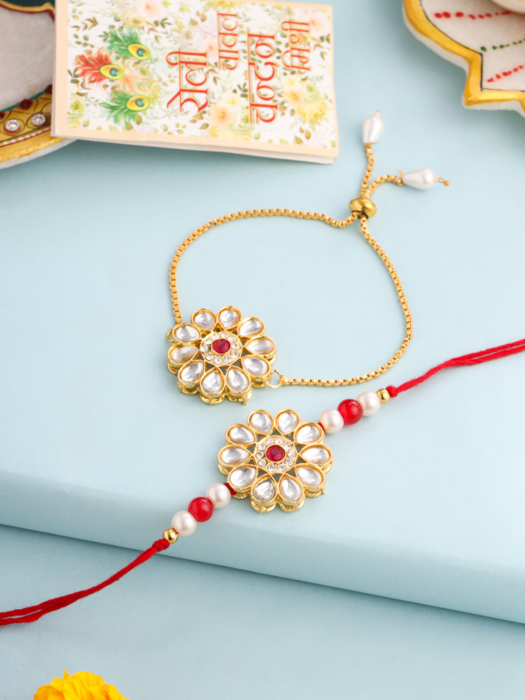NVR Set of 2 Gold Toned Kundan Studded Floral Design Bhaiya Bhabhi Rakhi Set with Roli Chawal Chandan & Mishri