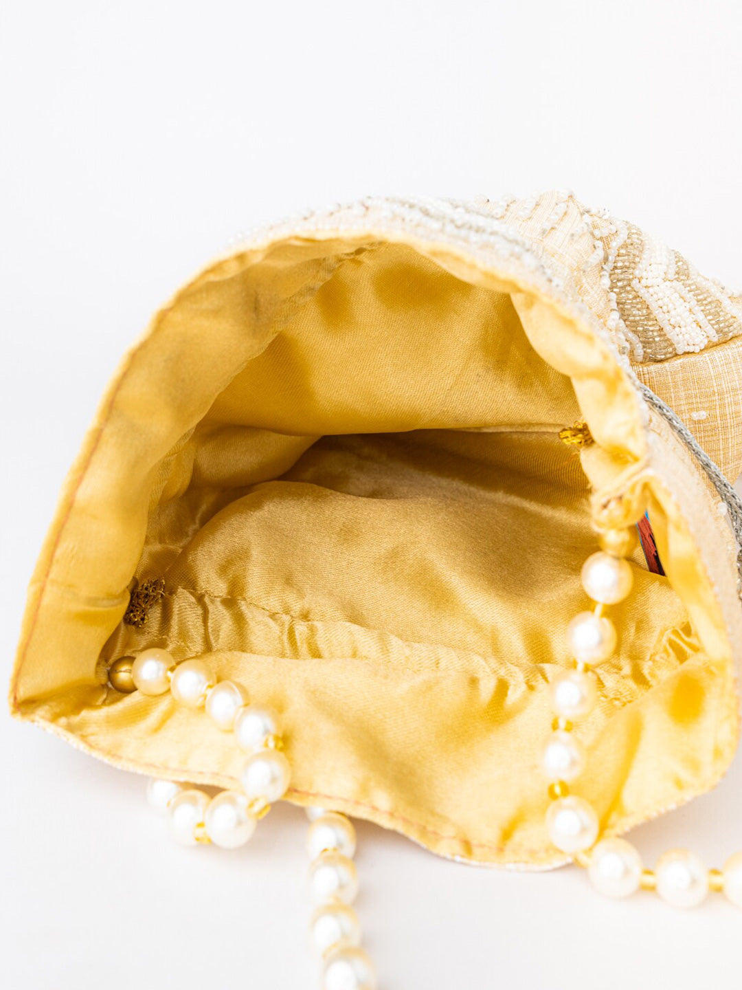 NR By Nidhi Rathi Cream-Coloured & Gold-Toned Embellished Potli Clutch - Distacart