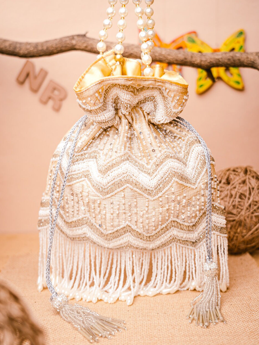 NR By Nidhi Rathi Cream-Coloured & Gold-Toned Embellished Potli Clutch - Distacart