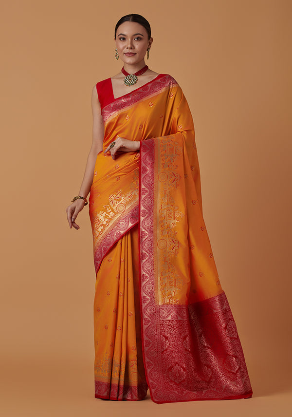 Monjolika Fashion Amber Banarasi Silk Blend SareeWith Traditional & Modern Dulha Dulhan Figure Zari Woven Detailing