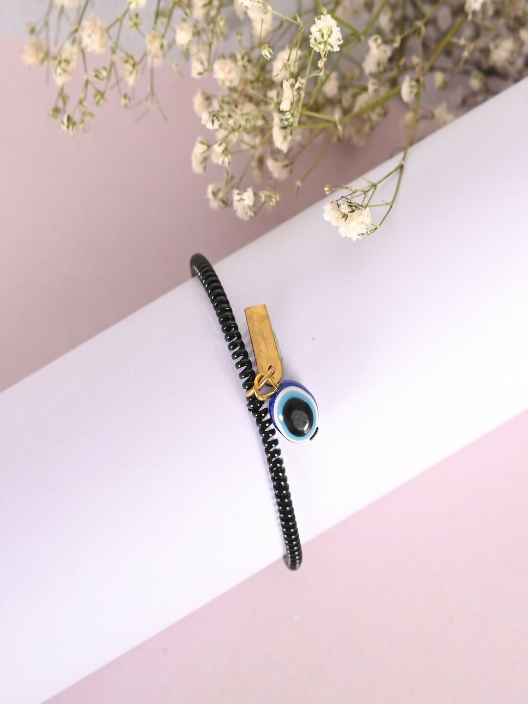 NVR Women & Men Black Evil Eye Spring Ring Rakhi With Roli Chawal - Distacart