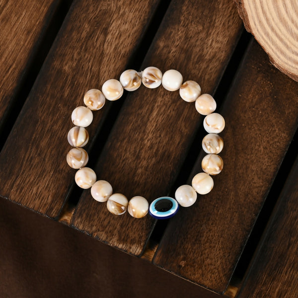 NVR Women & Men Cream-colored Evil Eye Elasticated Rakhi With Roli Chawal - Distacart