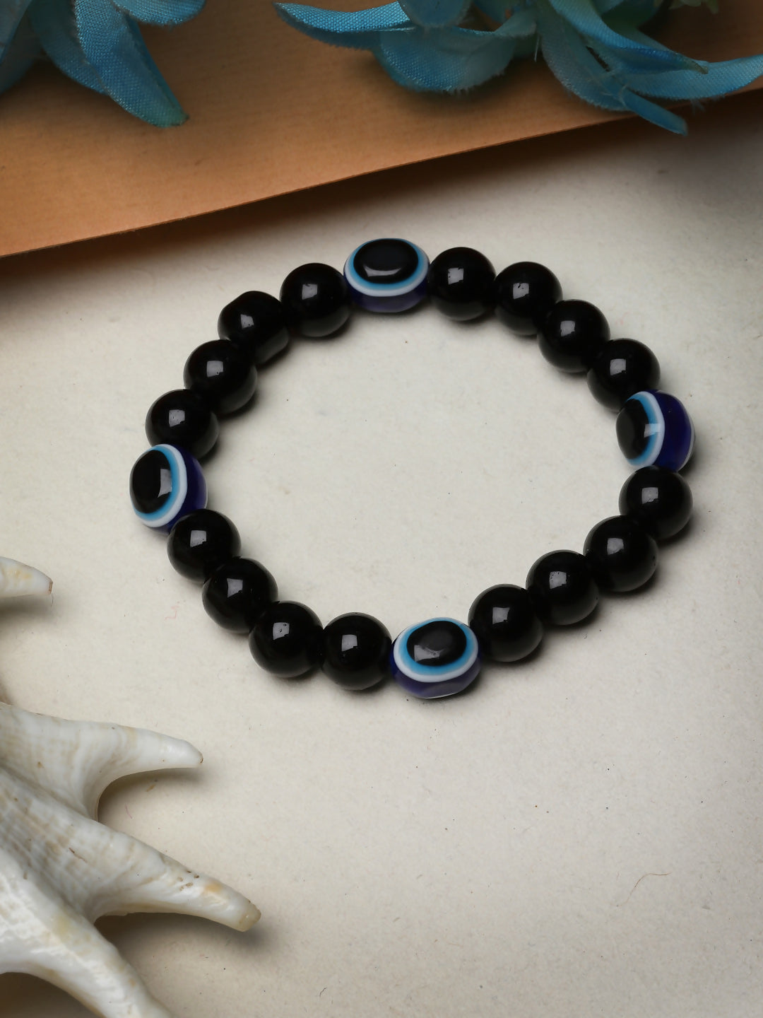 NVR Women & Men Black Evil Eye Elasticated Rakhi With Roli Chawal - Distacart