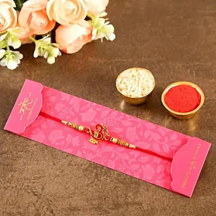 Auspicious Om Pearl Rakhi & Cadbury Fruit N Nut