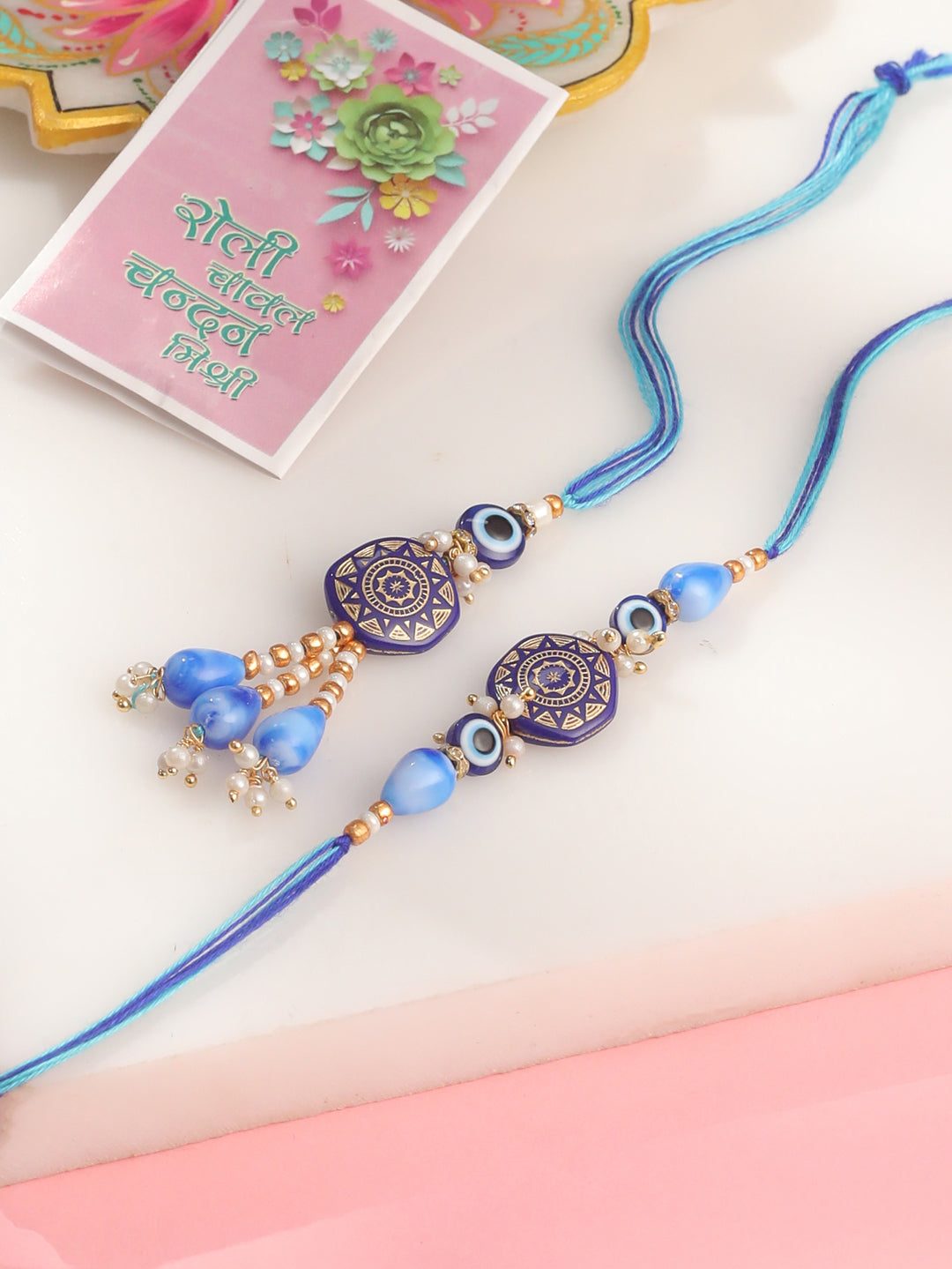 NVR Evil Eye Set of 2 Blue Artificial Beads Bhaiya Bhabhi Rakhi with Roli Chawal Chandan & Mishri - Distacart