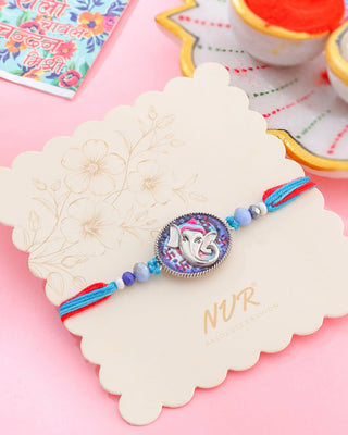 NVR Men Red & Blue Ganesh Ji Thread Rakhi with Roli Chawal Chandan & Mishri - Distacart