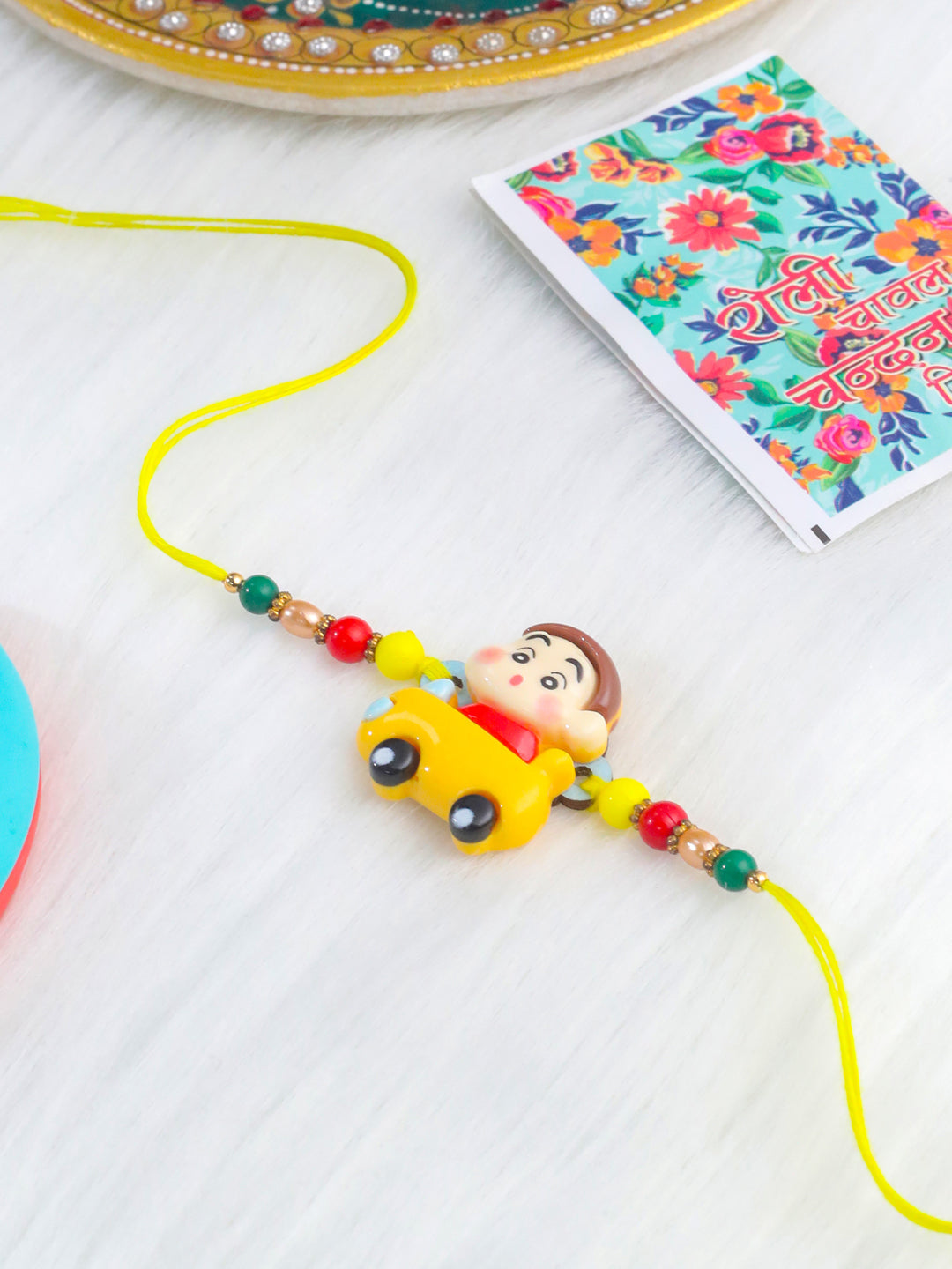 NVR Kids Yellow Cartoon Artificial Beads Rakhi with Roli Chawal Chandan & Mishri - Distacart
