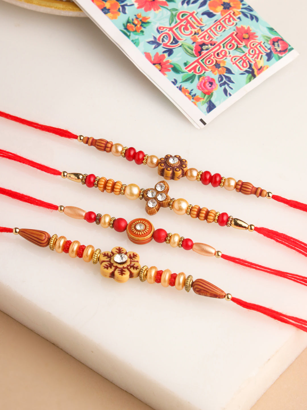 NVR Men Set of 4 Red Artificial Stones & Beads Floral Shape Thread Rakhi with Roli Chawal Chandan & Mishri - Distacart