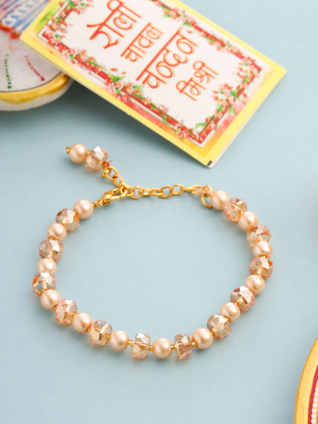 NVR Women Gold Toned Artificial Beads Wraparound Rakhi with Roli Chawal Chandan & Mishri - Distacart