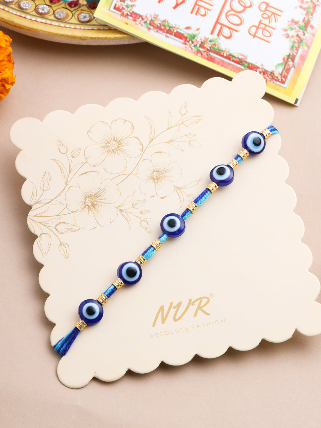 NVR Men's Blue Evil Eye Thread Rakhi with Roli Chawal Chandan & Mishri - Distacart