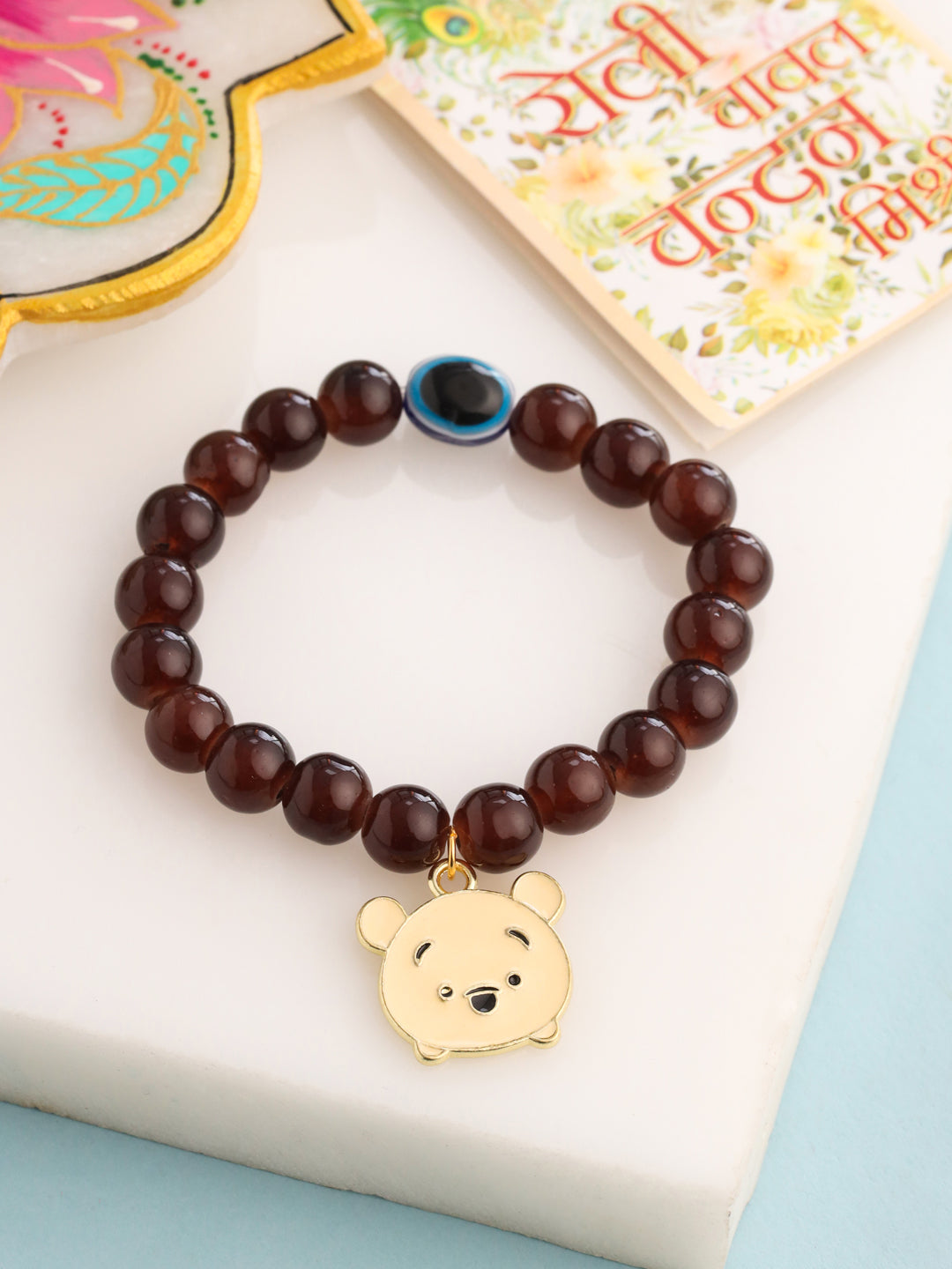 NVR Kids Cartoon Design Brown Artificial Beads Thread Rakhi with Roli Chawal Chandan & Mishri - Distacart