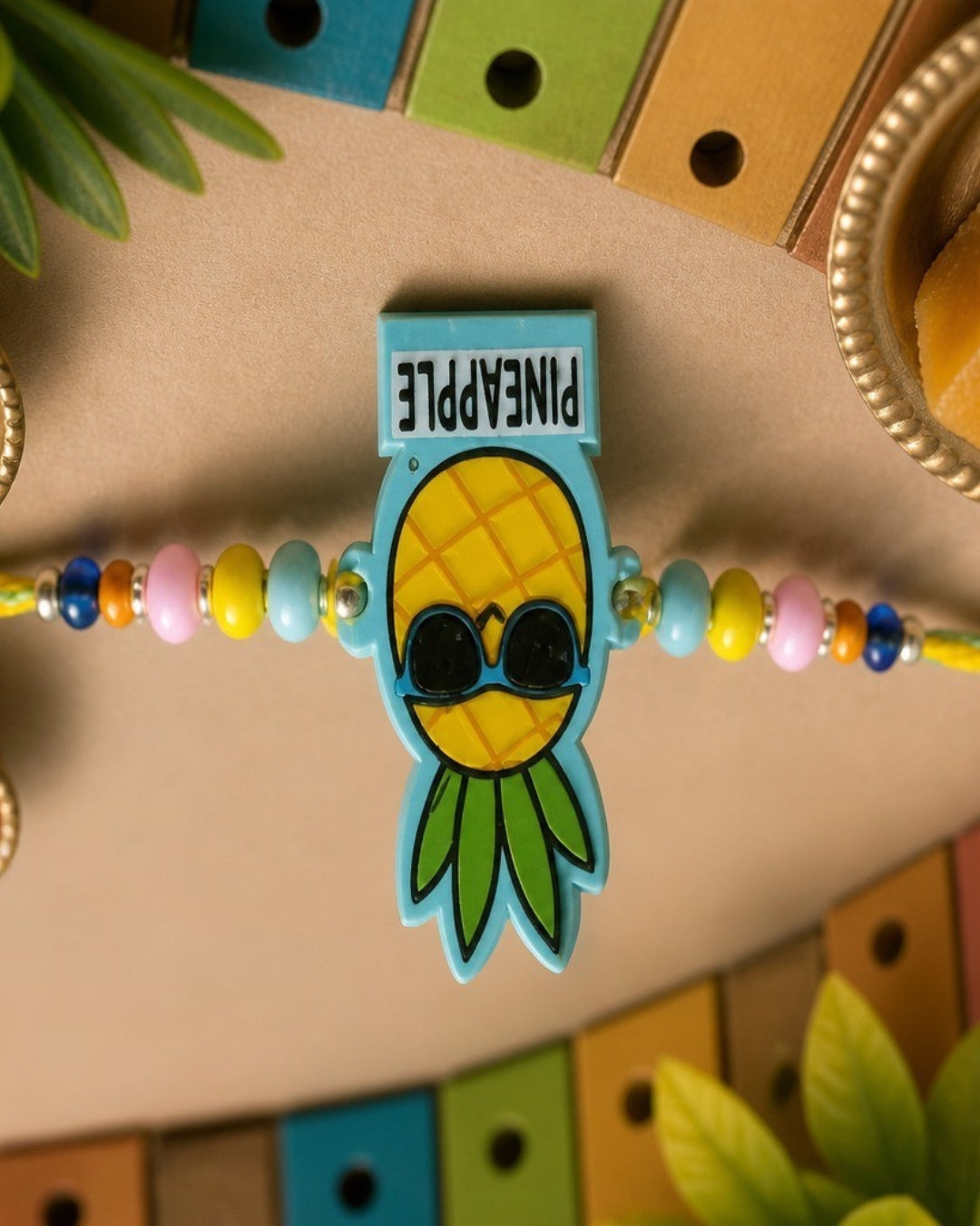 NVR Pineapple Design Kids Thread Rakhi with Roli Chawal Chandan Mishri - Dista