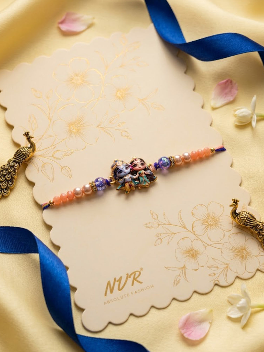 NVR Radha Krishna Multicolor Artificial Beads Thread Rakhi With Roli Chawal Chandan Mishri - Dista