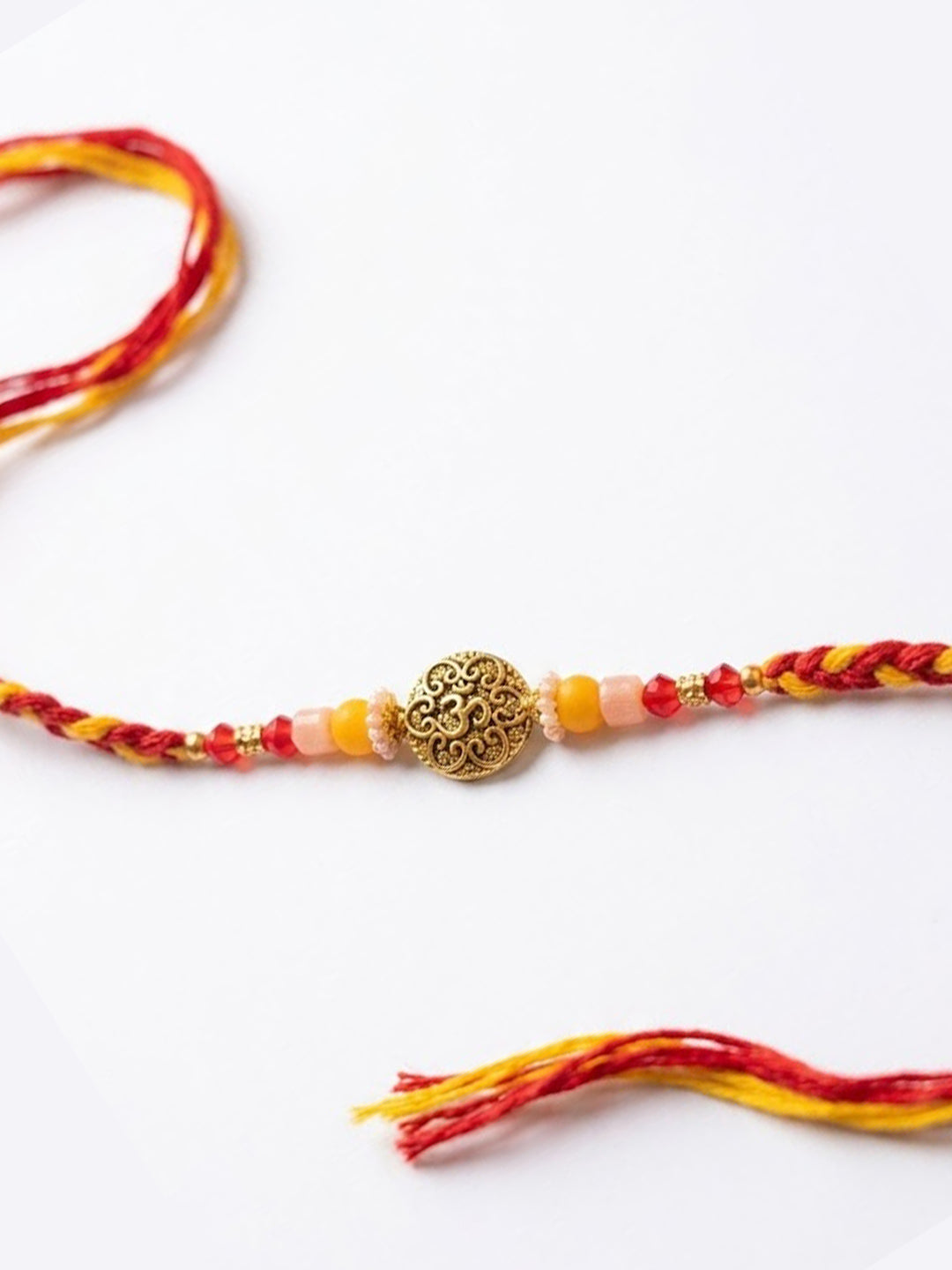 NVR Artificial Beads Decorative Om Design Religious Thread Rakhi with Roli Chawal Chandan - Dista