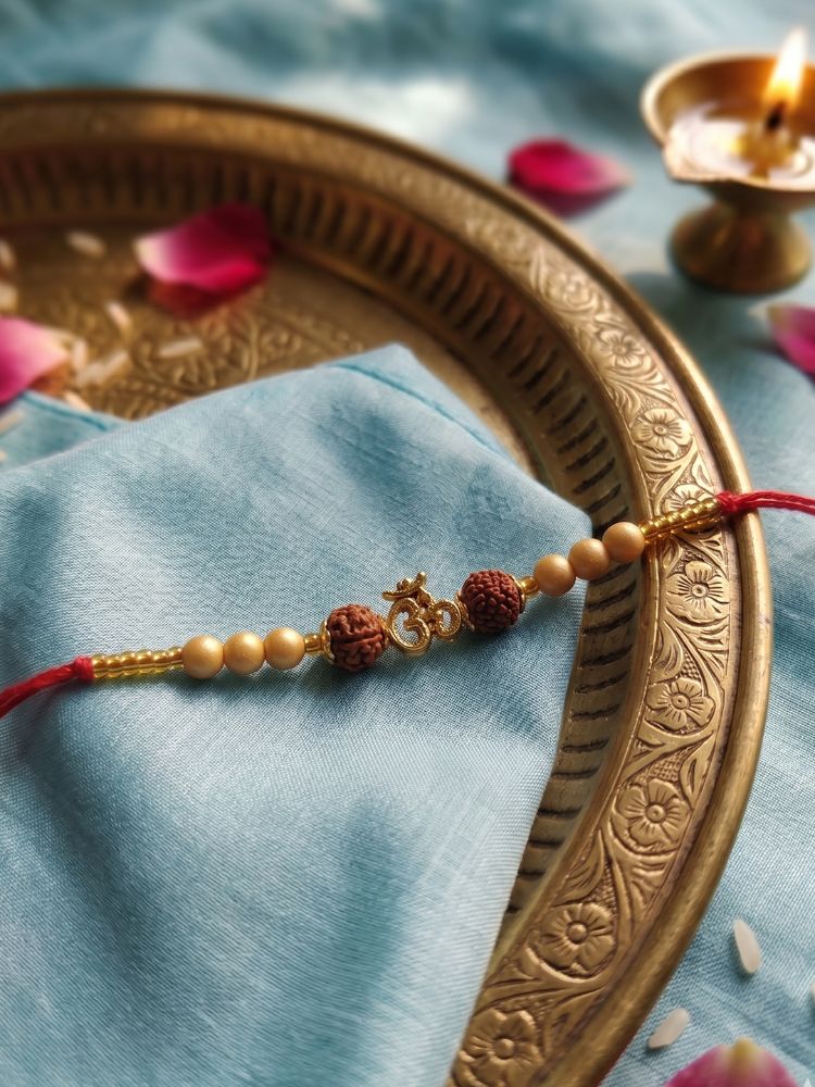 NVR Om Design Rudraksh Thread Rakhi with Roli Chawal Chandan Mishri - Dista