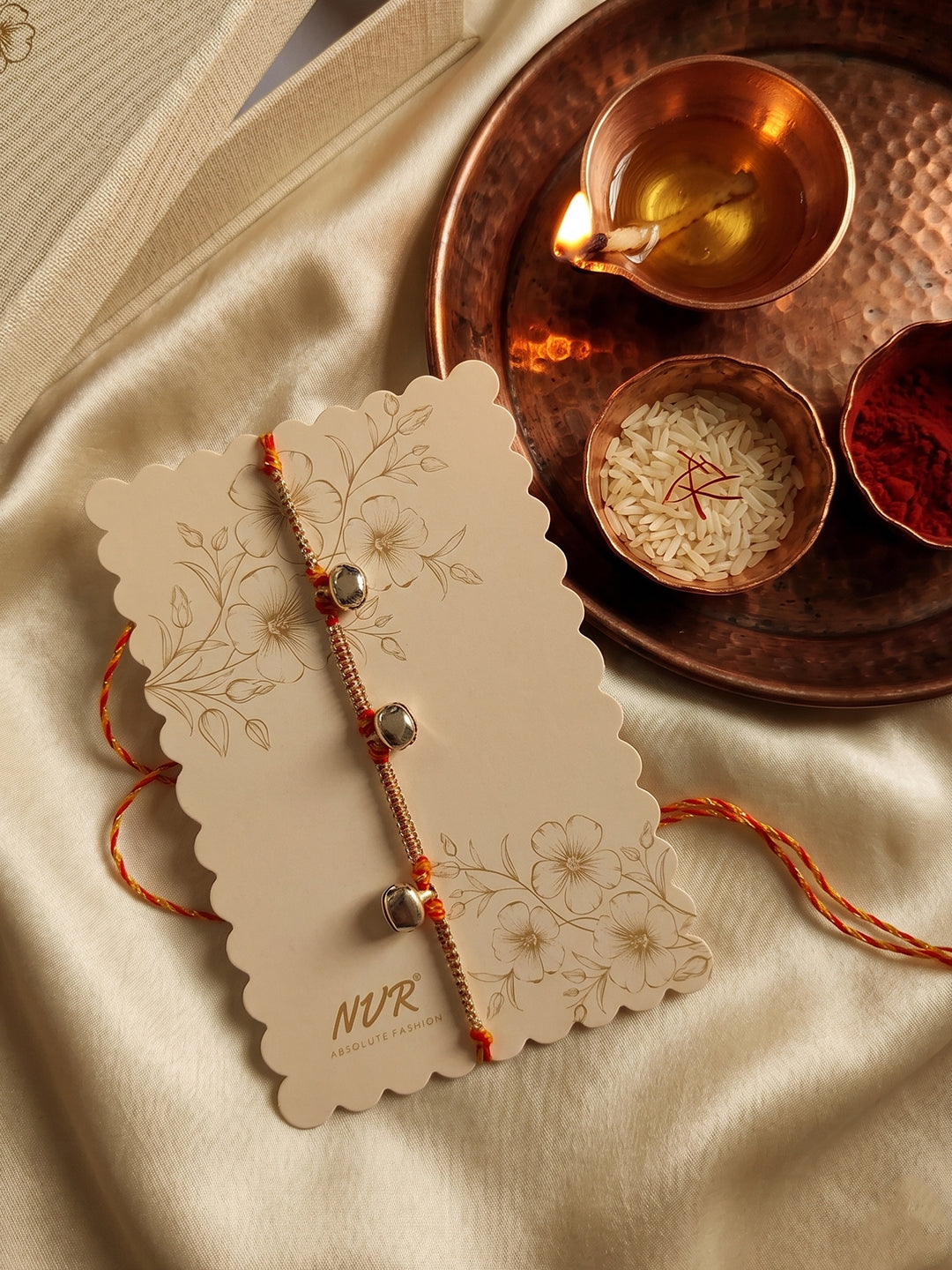 NVR Golden Ghungroo Thread Rakhi with Roli Chawal Chandan Mishri - Dista