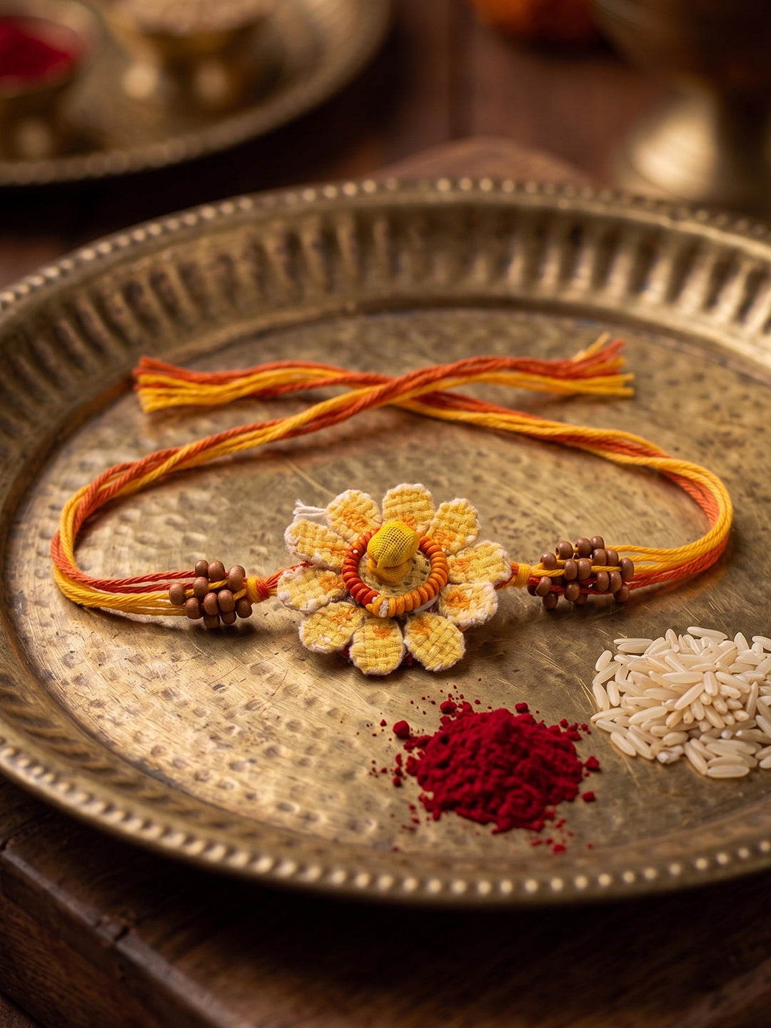 NVR Yellow Floral Seed Thread Rakhi with Roli Chawal Chandan Mishri - Dista