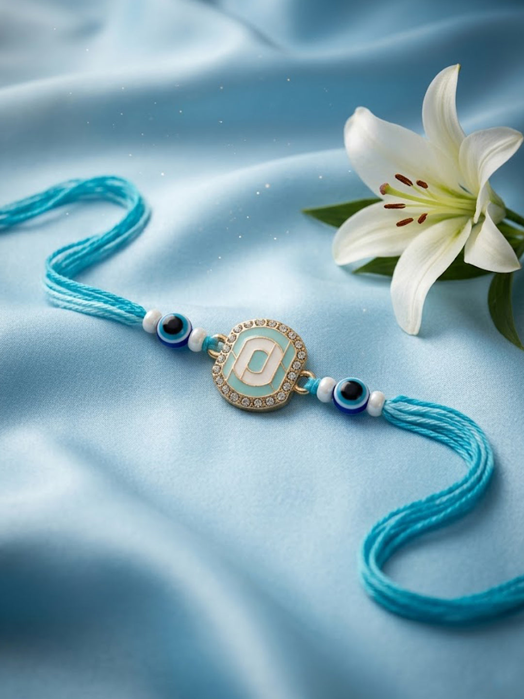 NVR Blue Evil Eye & Artificial Stones Oval Shape Thread Rakhi with Roli Chawal Chandan - Dista