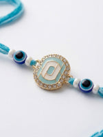 Thumbnail for NVR Blue Evil Eye & Artificial Stones Oval Shape Thread Rakhi with Roli Chawal Chandan - Dista