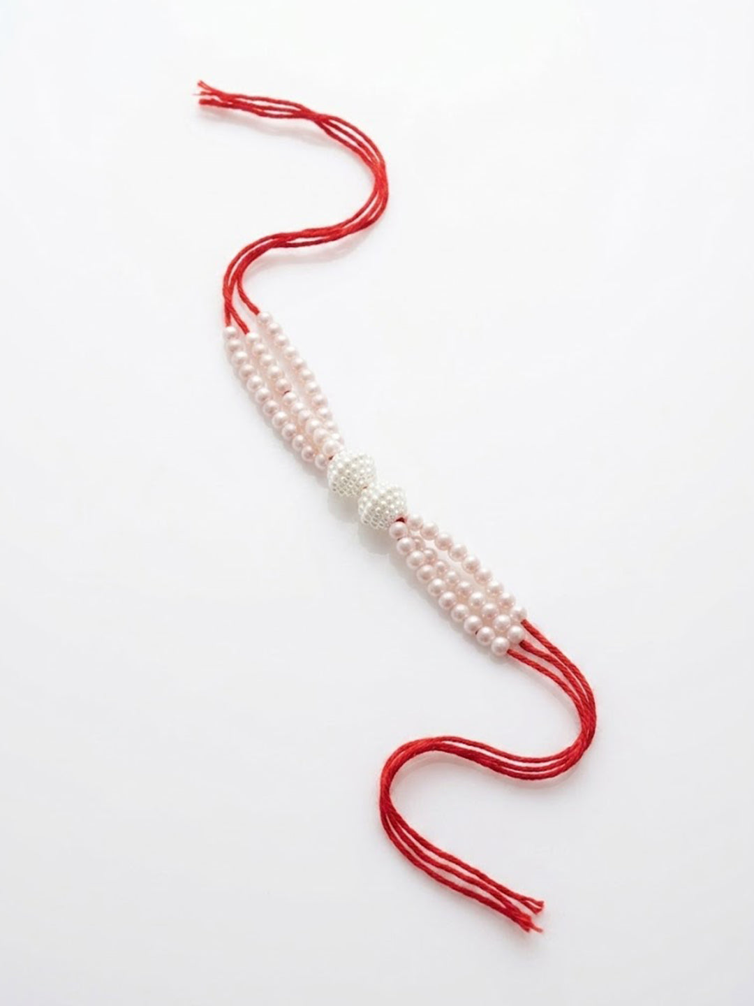 NVR White Pearls & Red Thread Rakhi with Roli Chawal Chandan Mishri - Dista