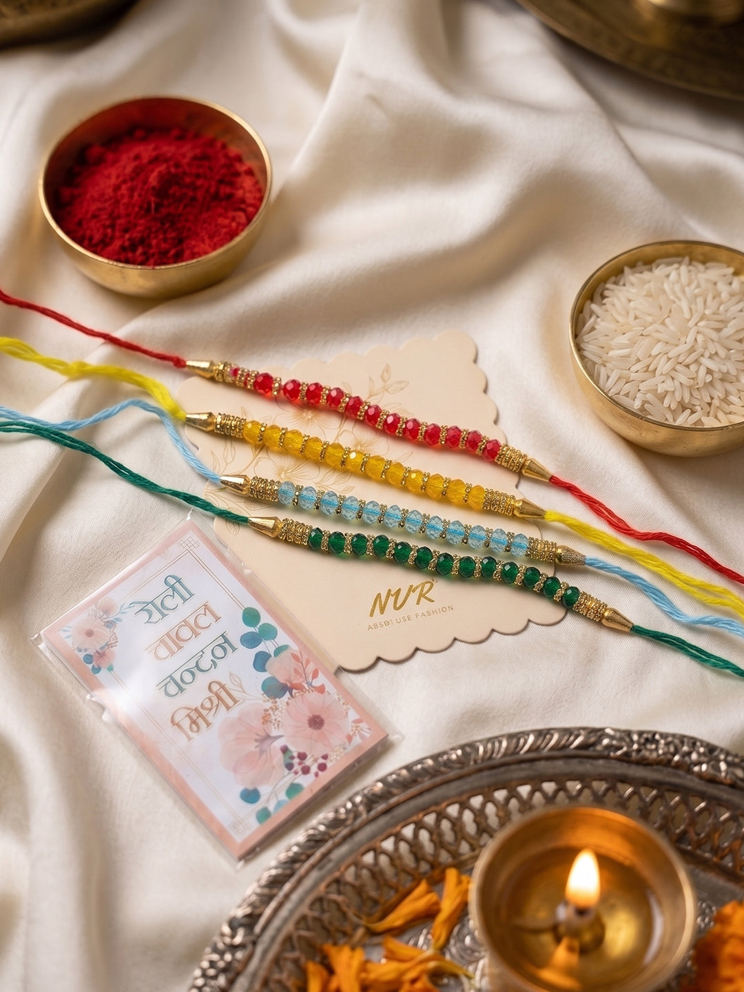 NVR Set of 4 Multicolor Artificial Beads Thread Rakhi with Roli Chawal Chandan Mishri - Dista