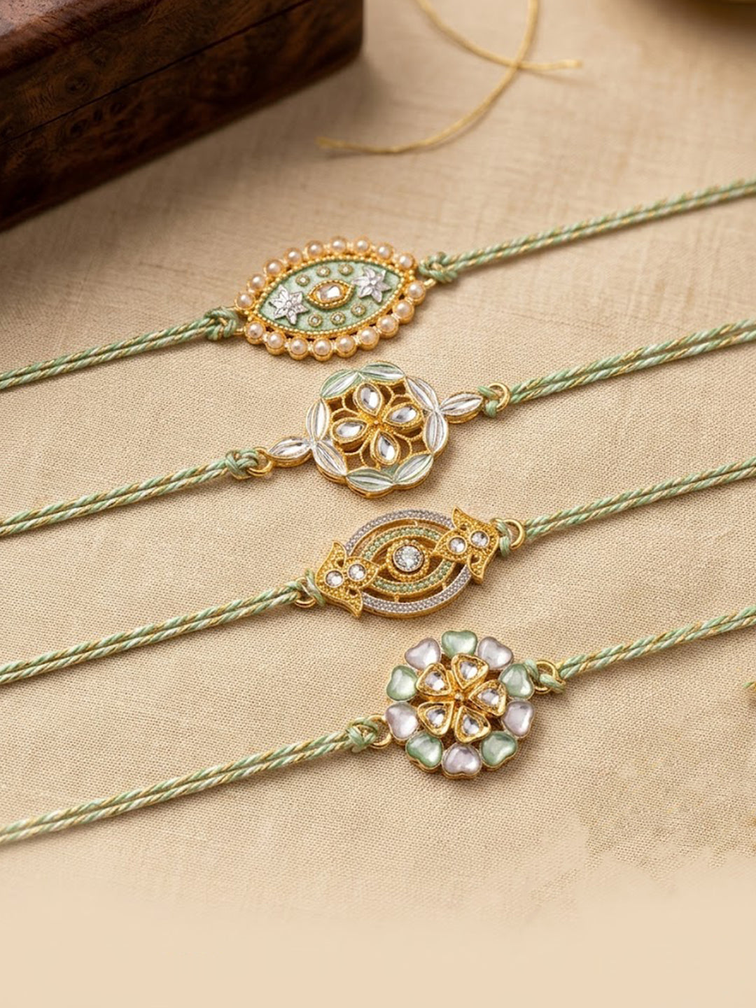 NVR Set of 4 White Artificial Stones & Green Thread Rakhi with Roli Chawal Chandan Mishri - Dista