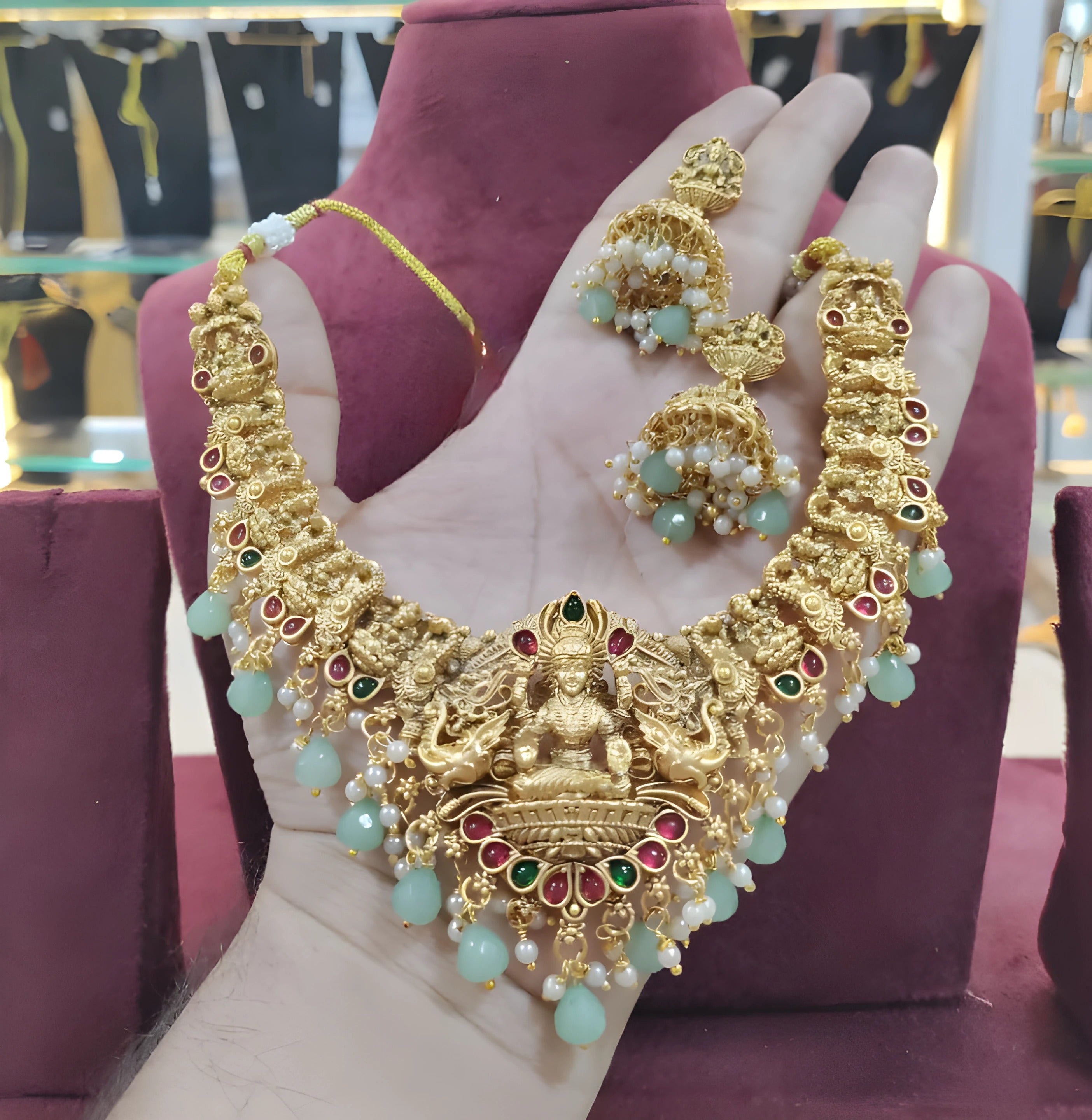 Jewel City Opulent Gold Peacock Lakshmi Temple Necklace Set - Handcrafted Antique Finish Bridal Jewelry with Emerald & Pearl Accent