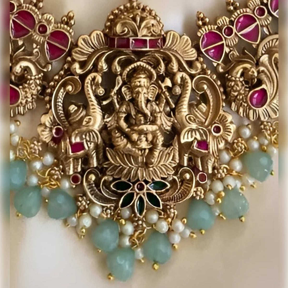 Jewel City Exquisite Ganesha Temple Jewelry Set - Antique Gold-Plated Necklace and Earrings with Ruby Pink Stones & Mint Green Beads (Premium Designer Collection)