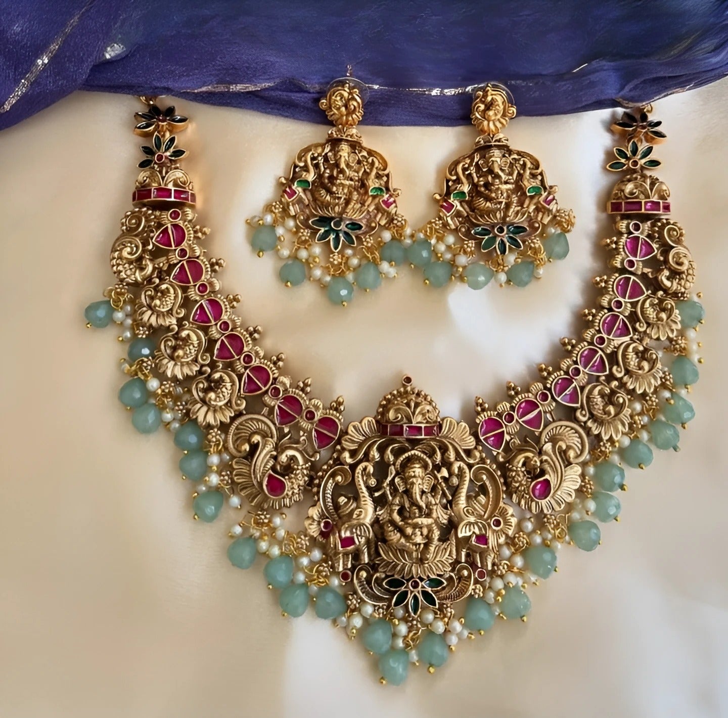 Jewel City Exquisite Ganesha Temple Jewelry Set - Antique Gold-Plated Necklace and Earrings with Ruby Pink Stones & Mint Green Beads (Premium Designer Collection)