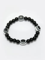 Thumbnail for NVR Women & Men Black Evil Eye Elasticated Rakhi With Roli Chawal - Distacart
