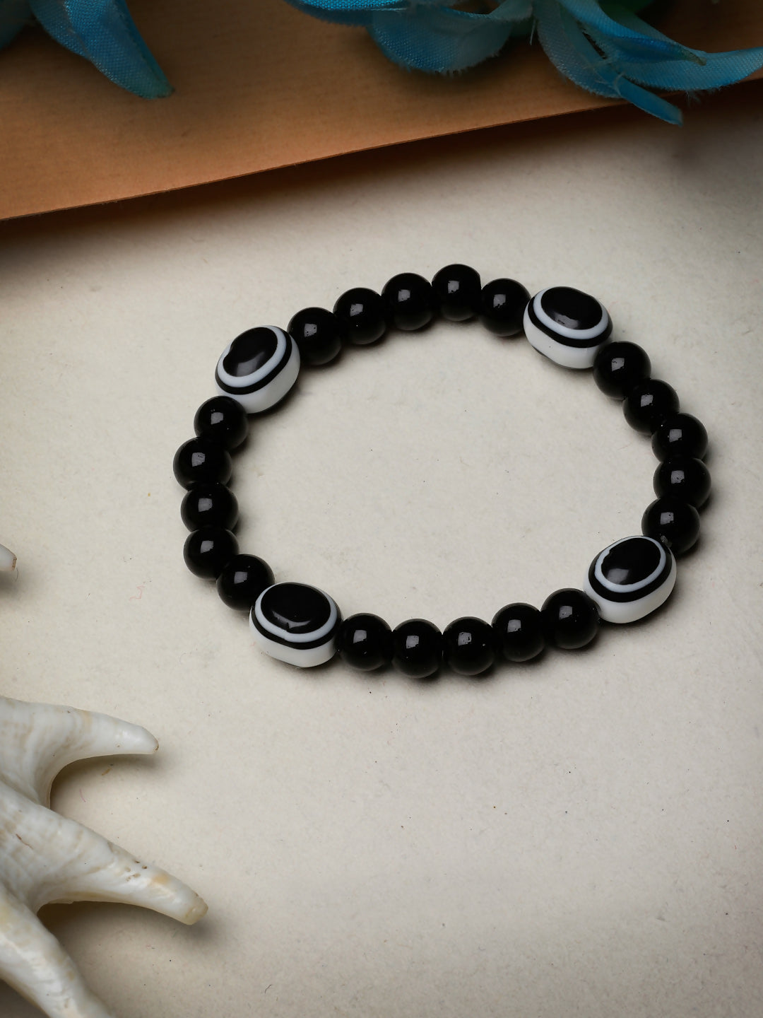 NVR Women & Men Black Evil Eye Elasticated Rakhi With Roli Chawal - Distacart