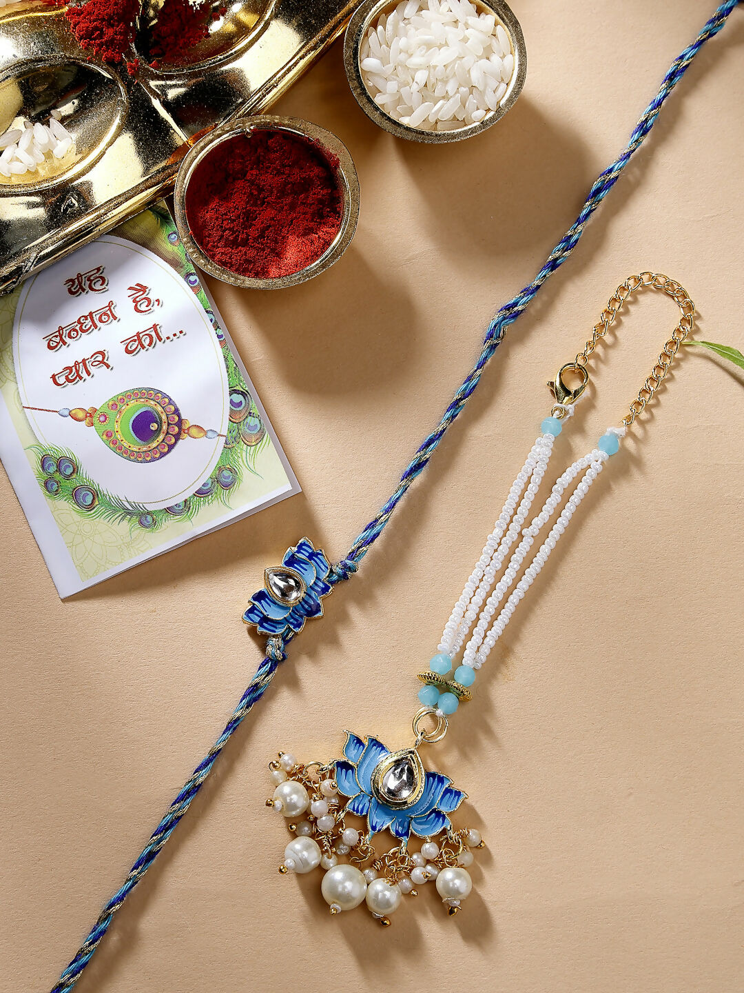 NVR Women & Men Set of 2 Blue Lotus Shape Kundan-Studded & Beaded Handcrafted Wraparound Rakhi Set With Roli Chawal - Distacart