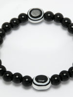 Thumbnail for NVR Women & Men Black Evil Eye Elasticated Rakhi With Roli Chawal - Distacart